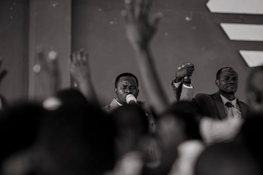 Grayscale Photo of a Man Preaching